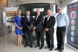 Hino staff accepting the dealer of the year award
